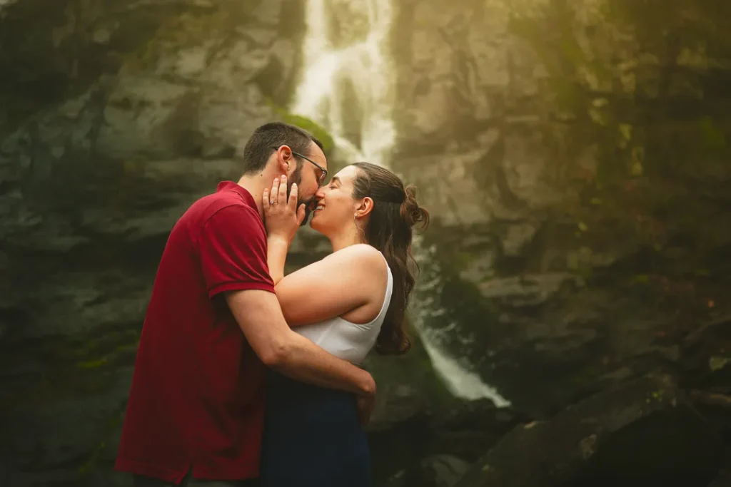 couple kissing under a waterfall