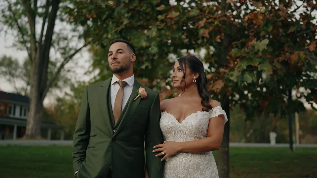 Bride & groom holding arms posing with fall view at, 48 Fields