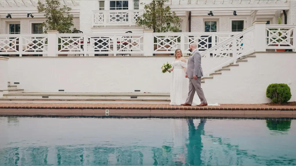 Bride & Groom walking next to pool at, Keswick Vineyards