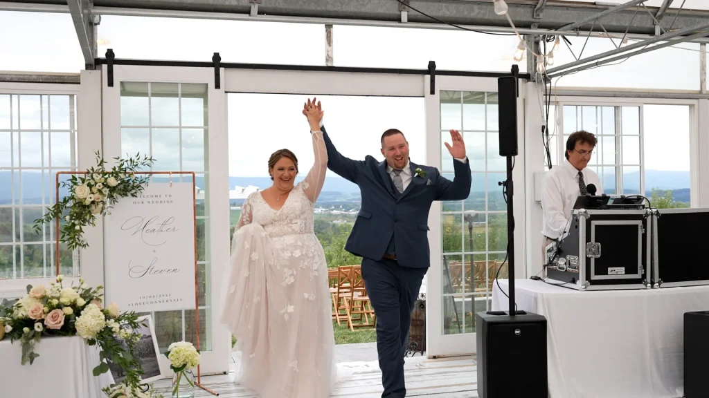 wedding couple entering their reception at the green house at Showalters Orchard in Timberville Virginia