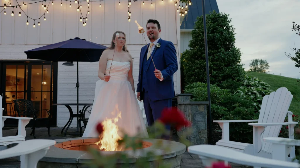 bride and groom roasting smores at The Barn at Willow Brook Wedding Reception